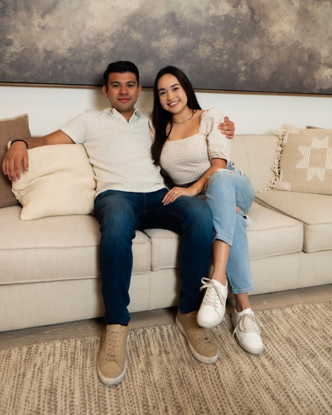 Alec and Lely Almuina sitting together on a sofa
