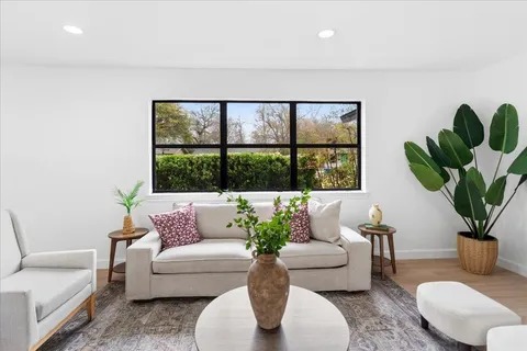A bright, freshly renovated living room with a large window
